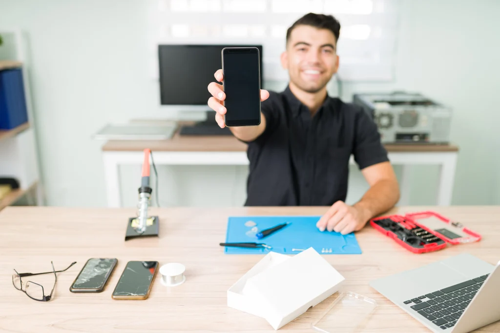 just as new happy young man showing fixed smartphone smiling technician repairing broken screen smartphone 11zon
